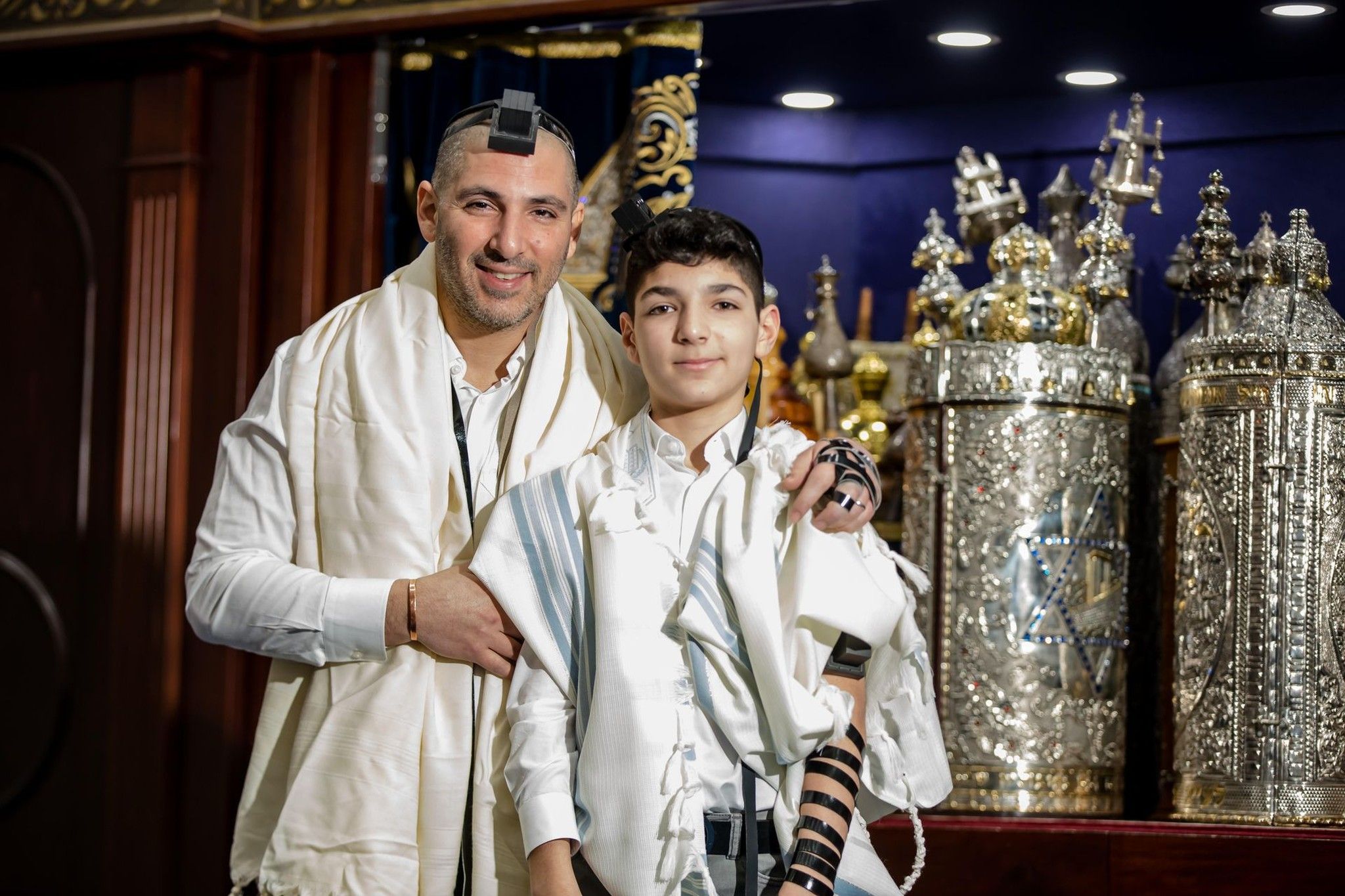 Bar mitzvah boy in a white tallit and tefillin