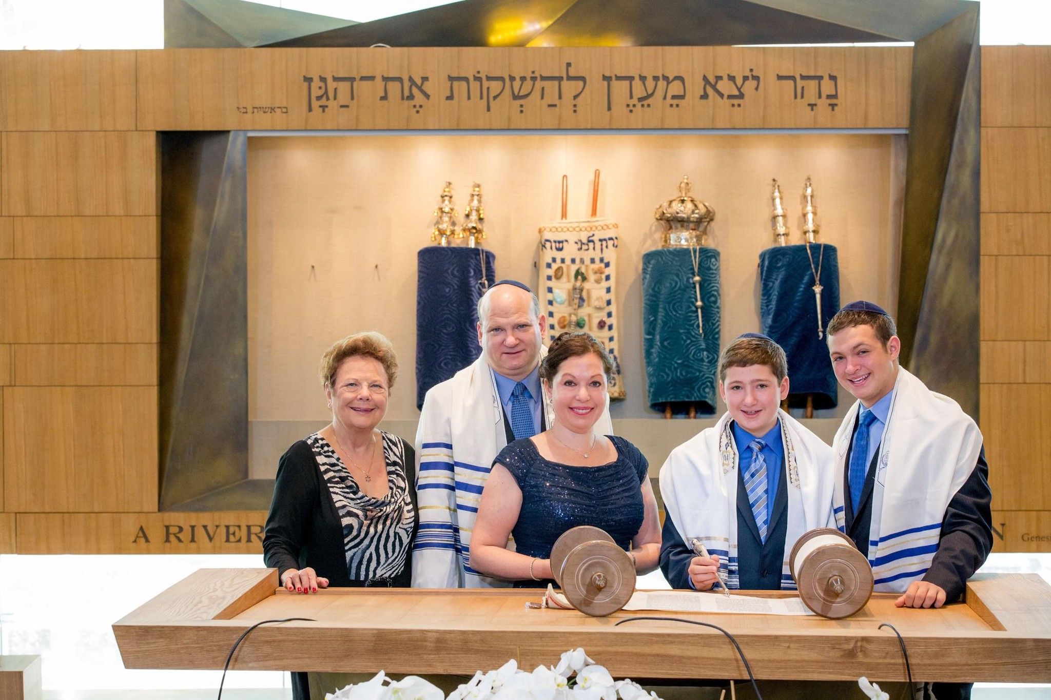 Family at bimah with Torah scrolls