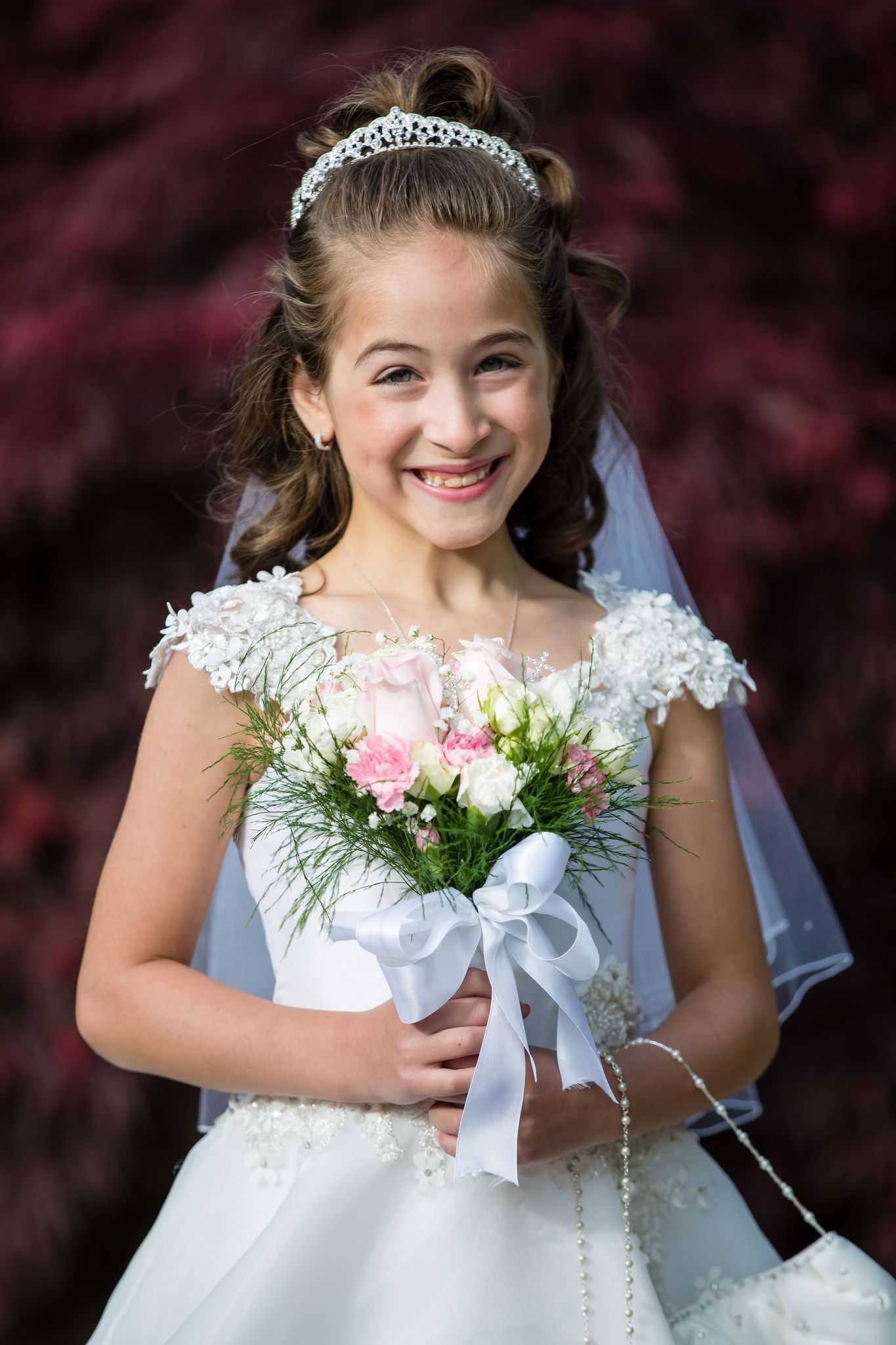Girl in communion dress holding bouquet