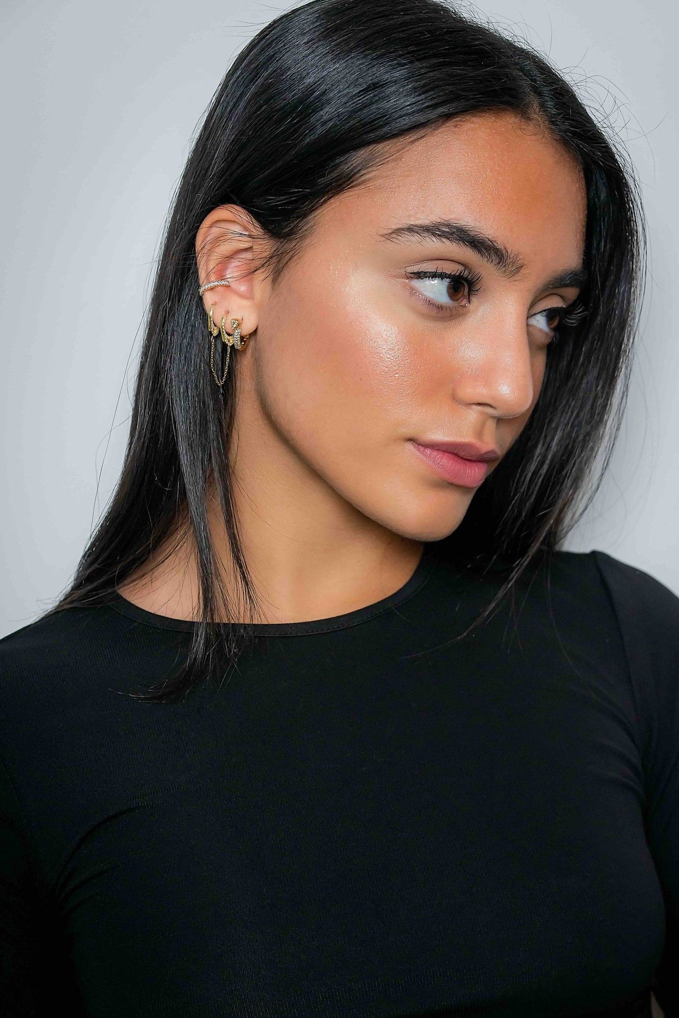 Model wearing gold stud earrings