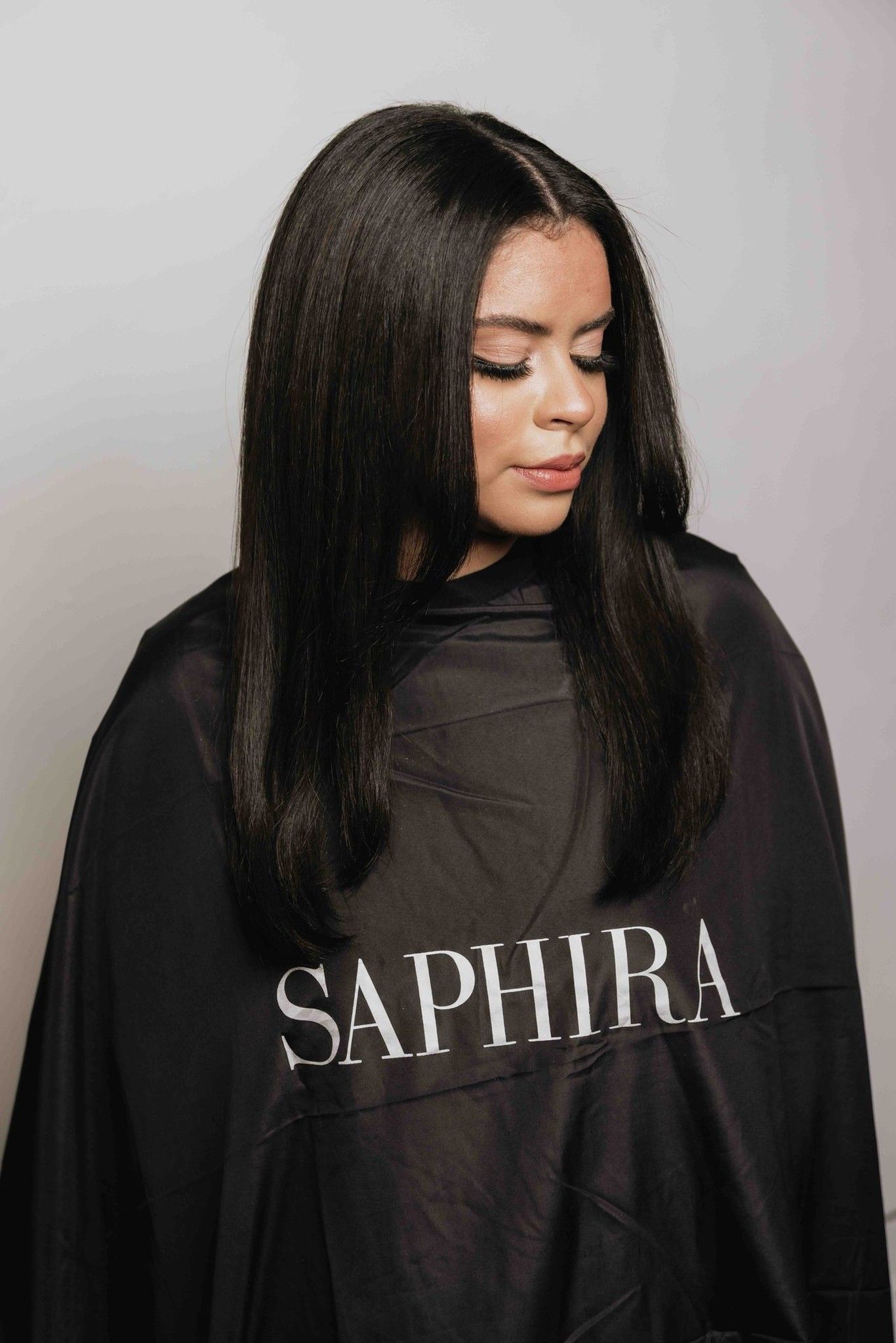 Model wearing a Saphira salon cape