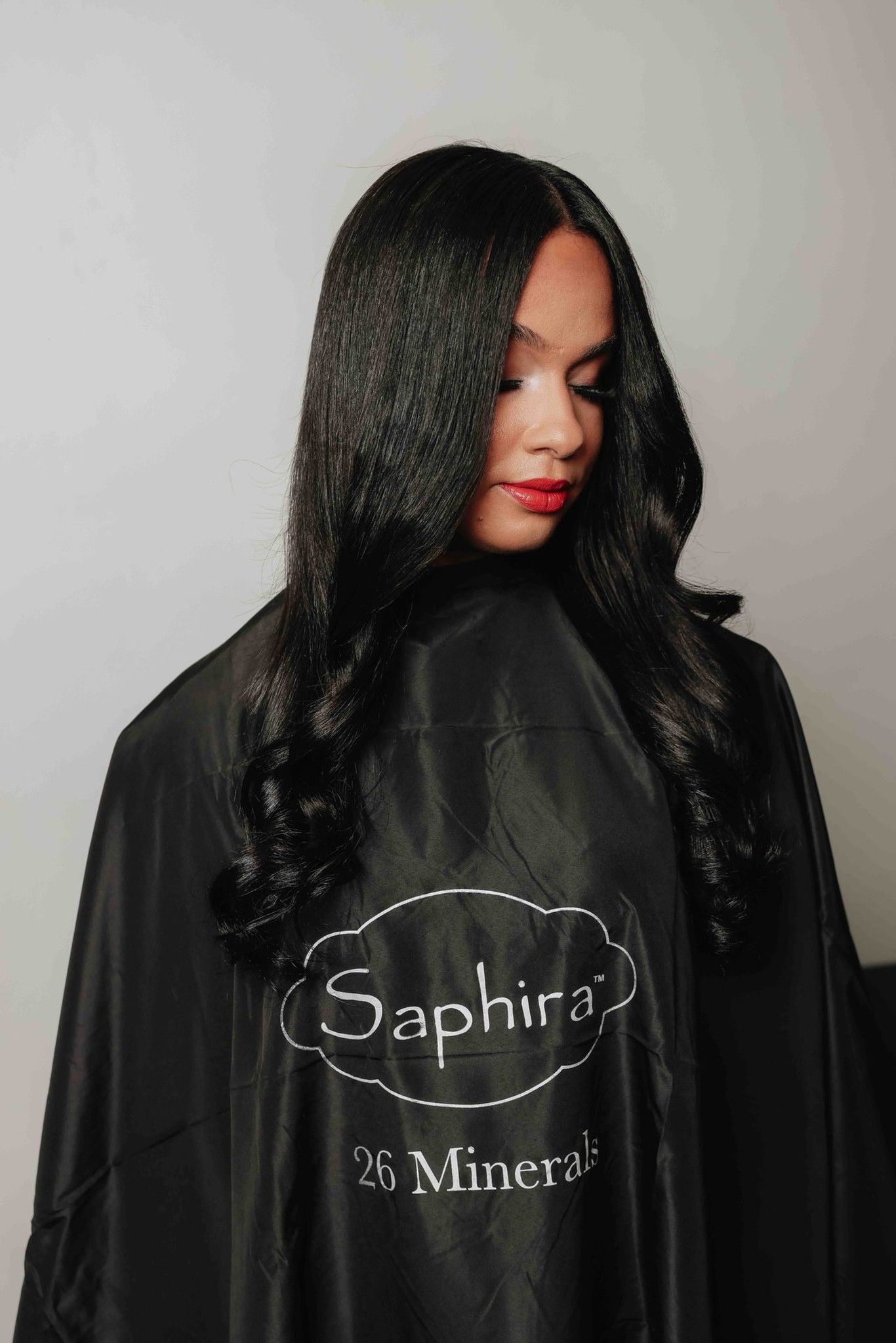 Back view of model in a Saphira salon cape