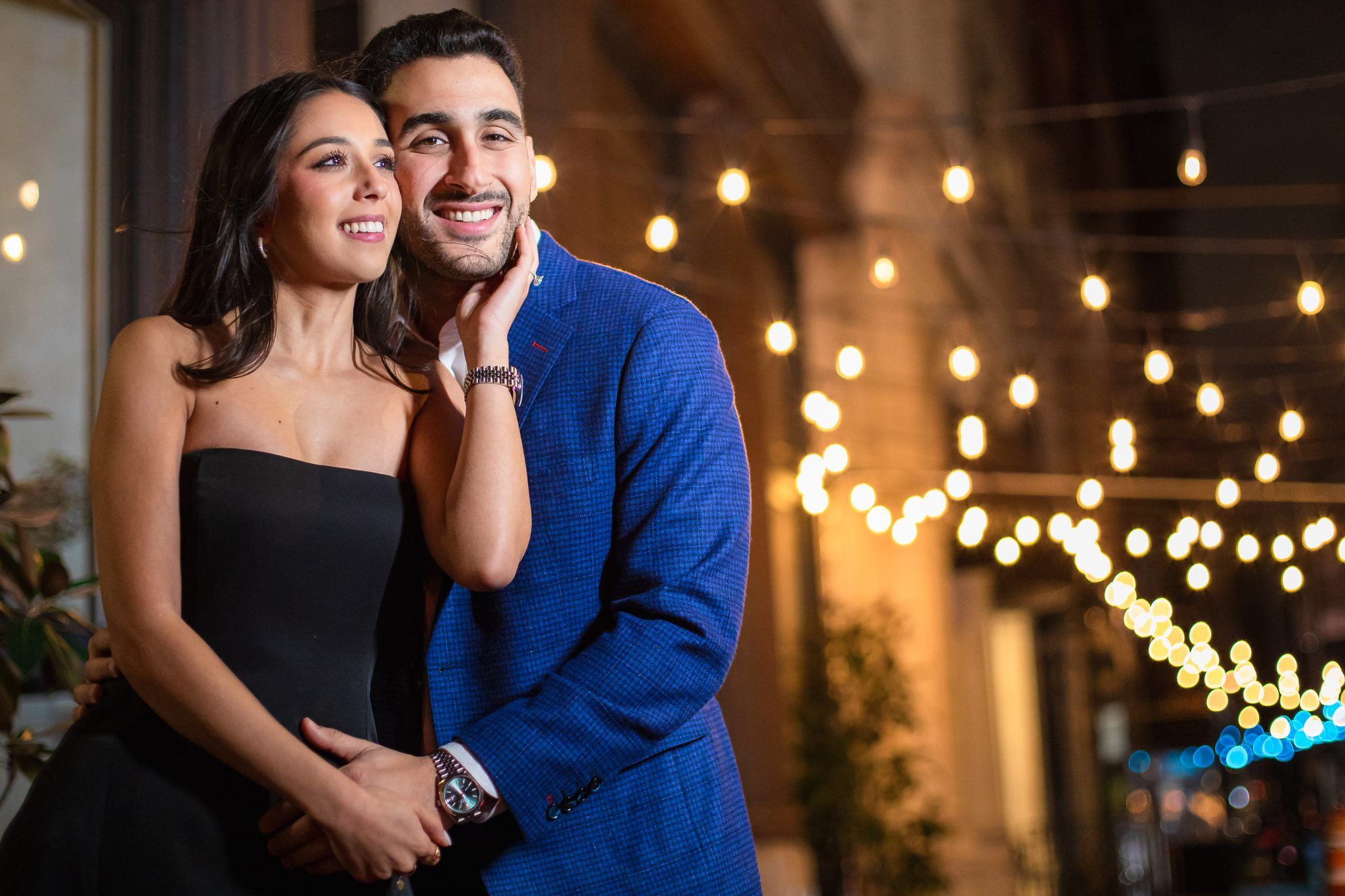 Couple under string lights at night
