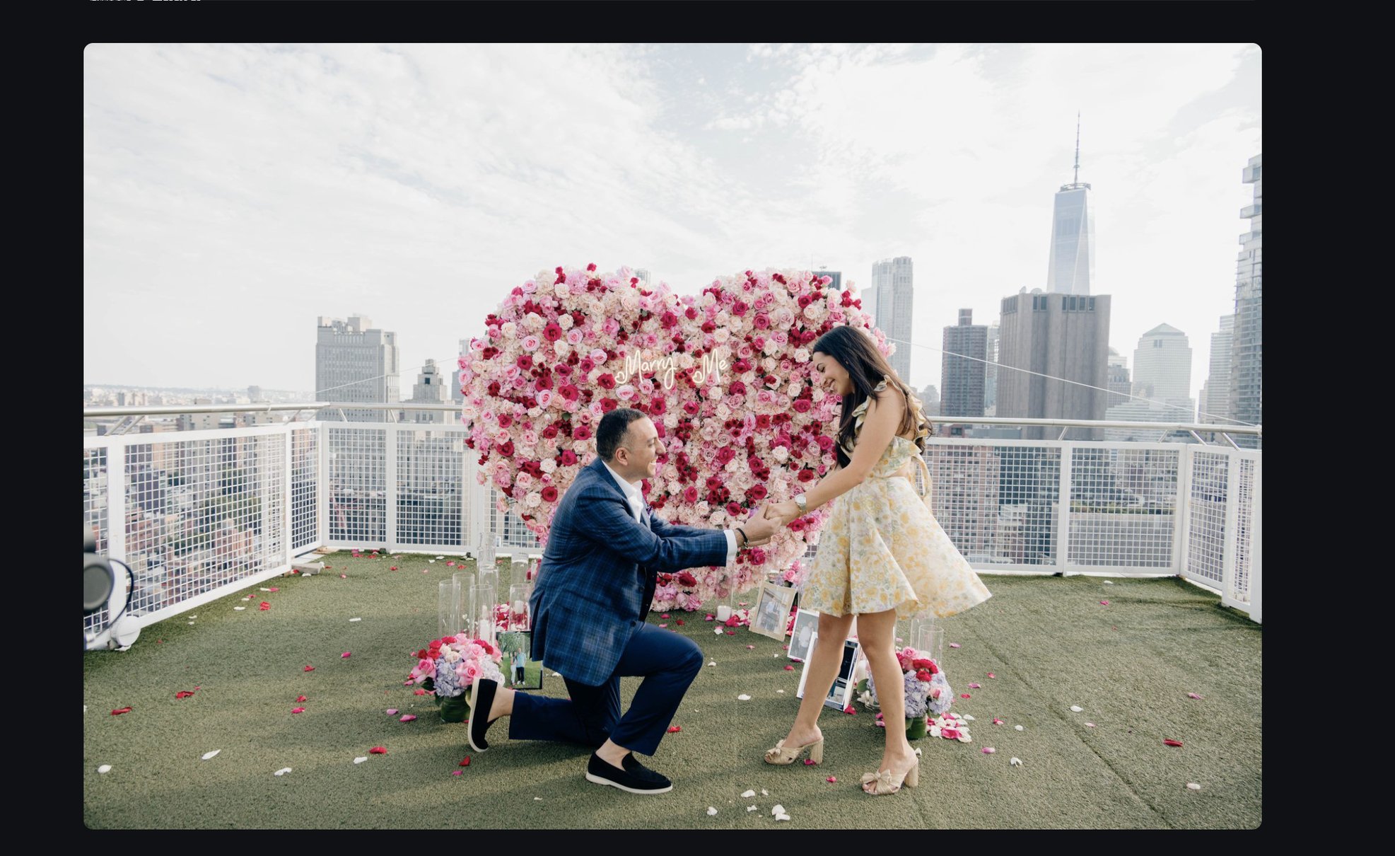 Proposal on a rooftop with heart-shaped flower wall